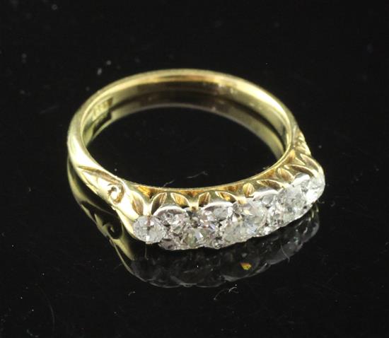 An early 20th century 18ct gold and graduated five stone diamond and rose cut diamond half hoop ring, size N.